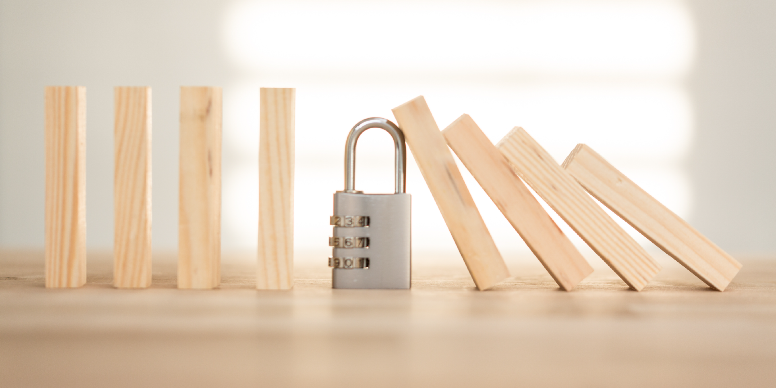 Business Continuity Padlock stopping building blocks falling over