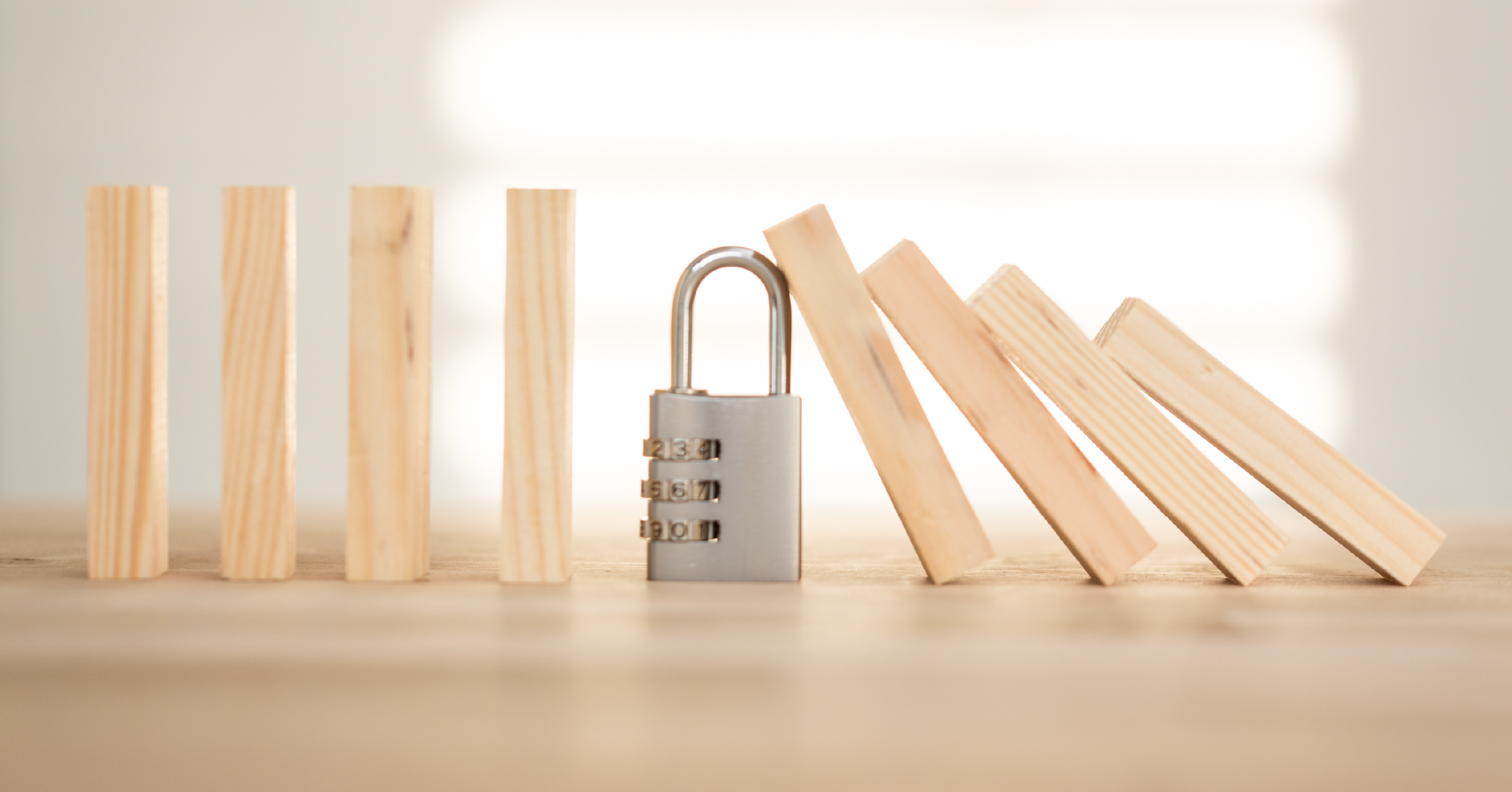 Business Continuity Padlock stopping building blocks falling over